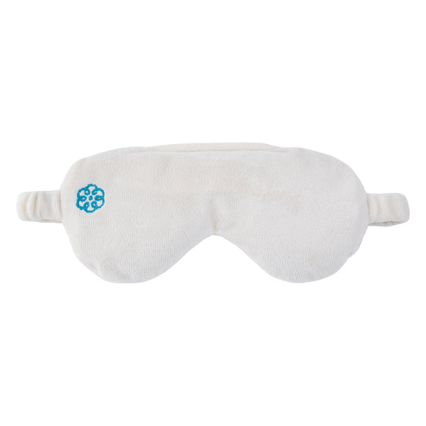 A plush white sleep mask with a small blue geometric logo on the left side, shown against a plain white background.