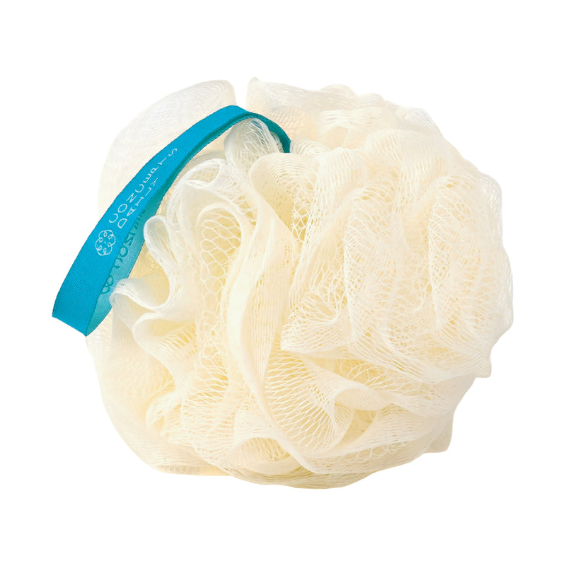 A cream-colored compostable mesh loofah bath sponge with a bright blue handle, featuring a white paper tag with the brand name Daily Concepts