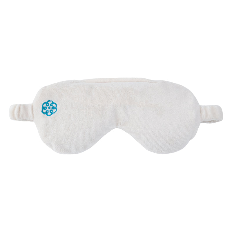 A plush white sleep mask with a small blue geometric logo on the left side, shown against a plain white background.